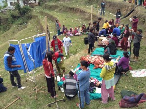 Staff from Gaurishankar Hospital attend to injured patients on the grass outside the hospital several days after the earthquake.
