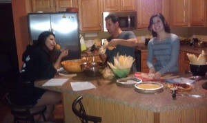 Pedro making tamales with daughters Ana and Valeria.