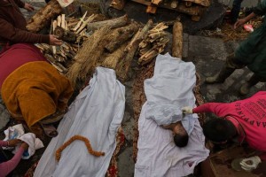 "Bodies are prepared for cremation during a Hindu ritual at the Pashupatinath Temple in Kathmandu on April 28, 2015, three days after a 7.8 magnitude earthquake devastated Nepal, killing at least 7,000 people and causing untold damage." Photo and caption by James Nachtwey, TIME Magazine, May 8, 2015.